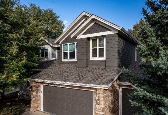 A house featuring a gray shingle roof. A house featuring a gray shingle roof.