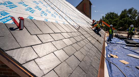 Residential roofing contractors repairing a roof.