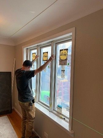 A person installing or inspecting three large.