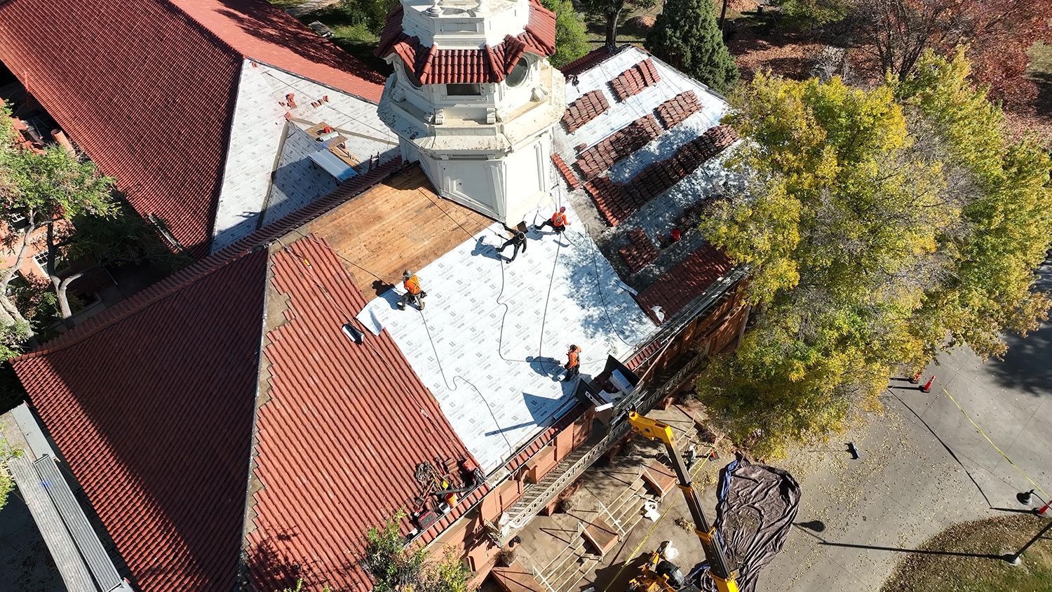 Local Roofing Contractor in Denver CO replacing tile roof on multi-story home.