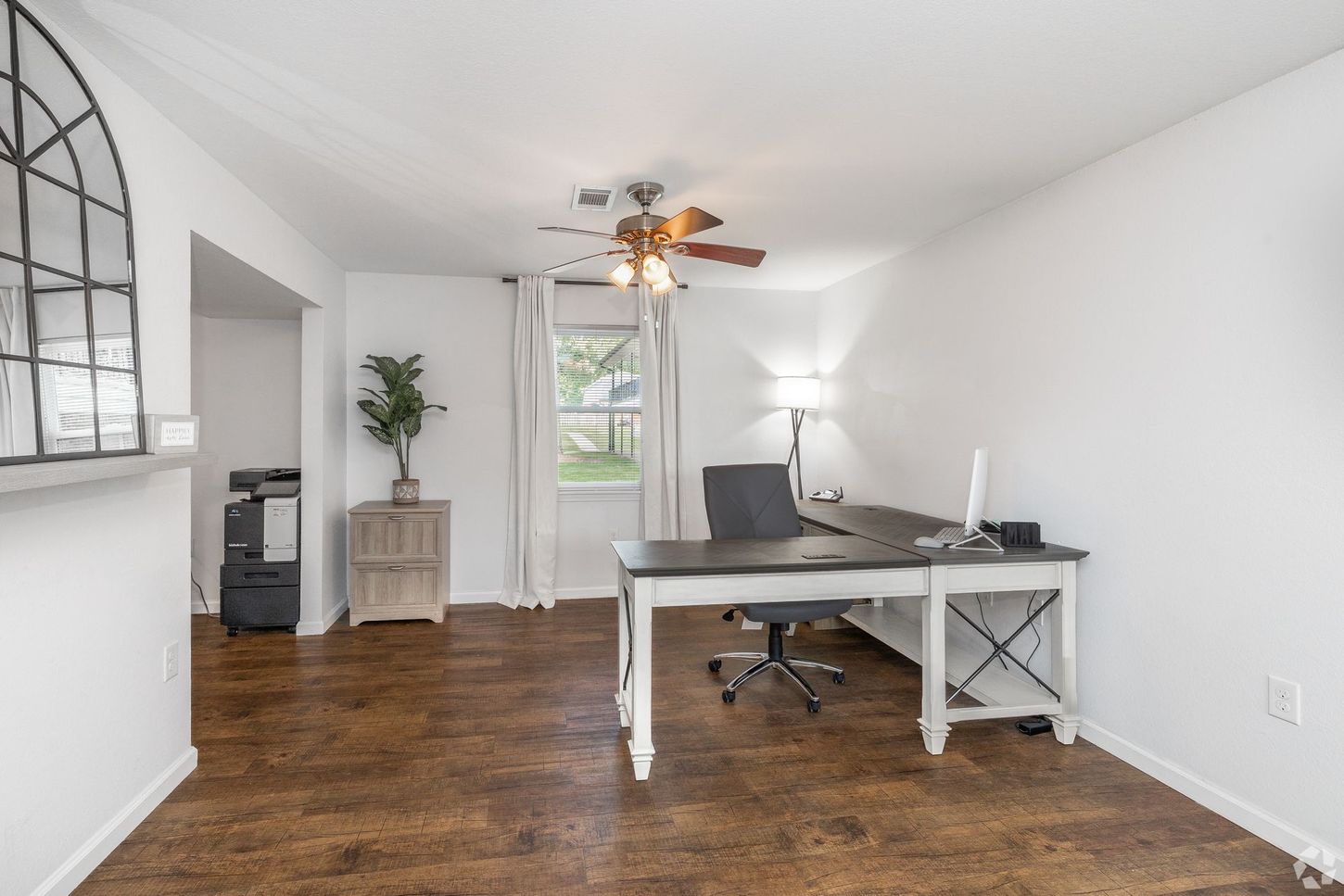 living room area with desk in it to show the maximized space possible