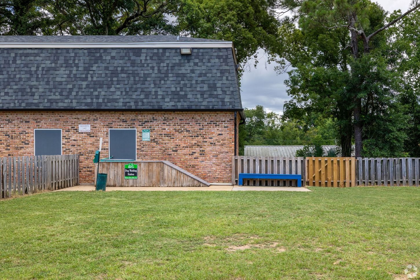 Dog wash station in front of maintenance building at dog park