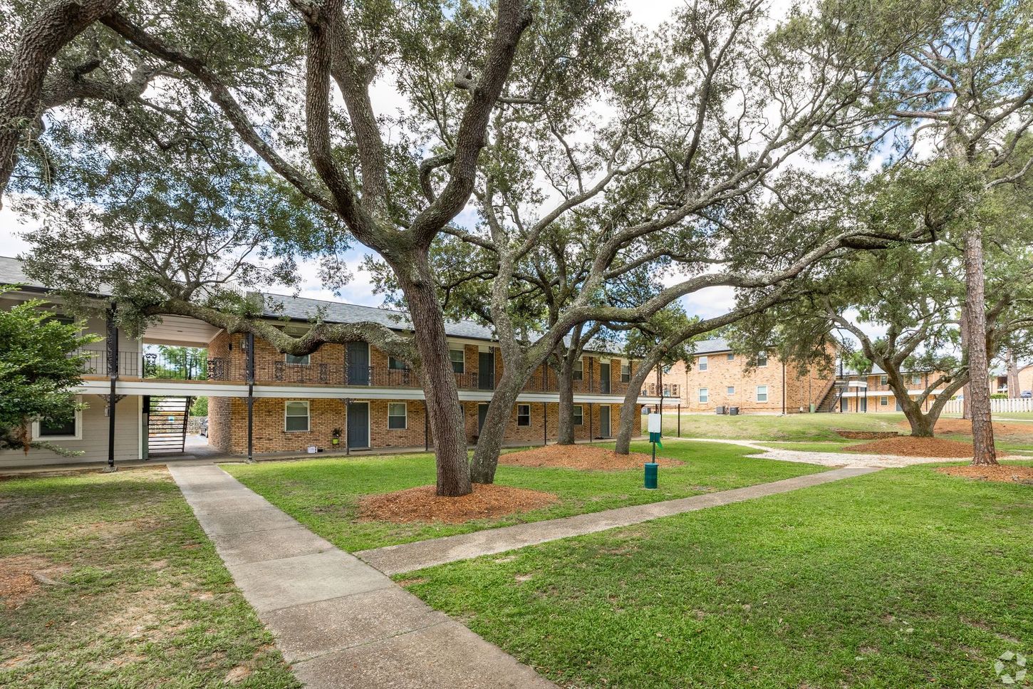 Courtyard area with trees and apartment buildings and sidewalk