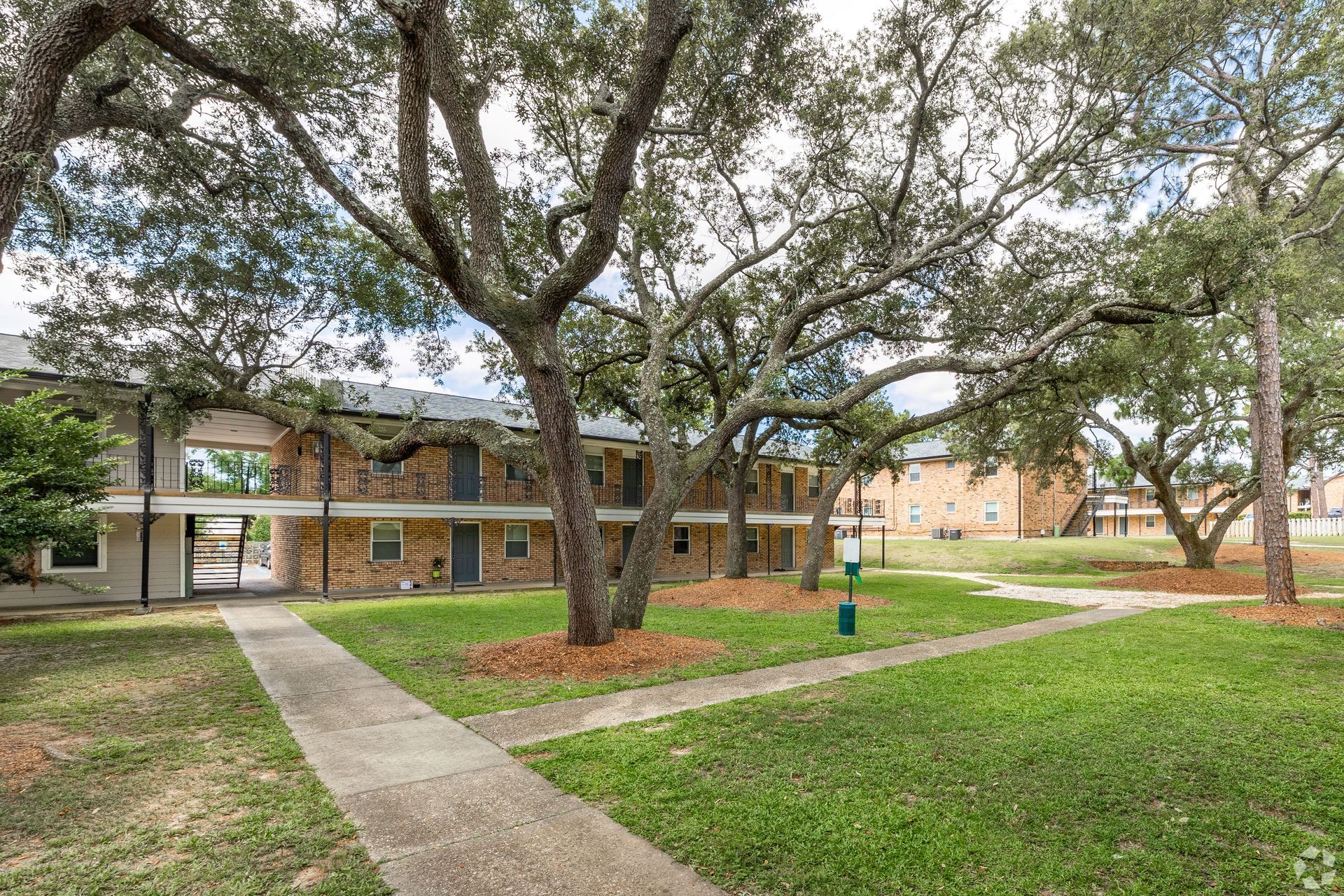 Courtyard area with trees and apartment buildings and sidewalk