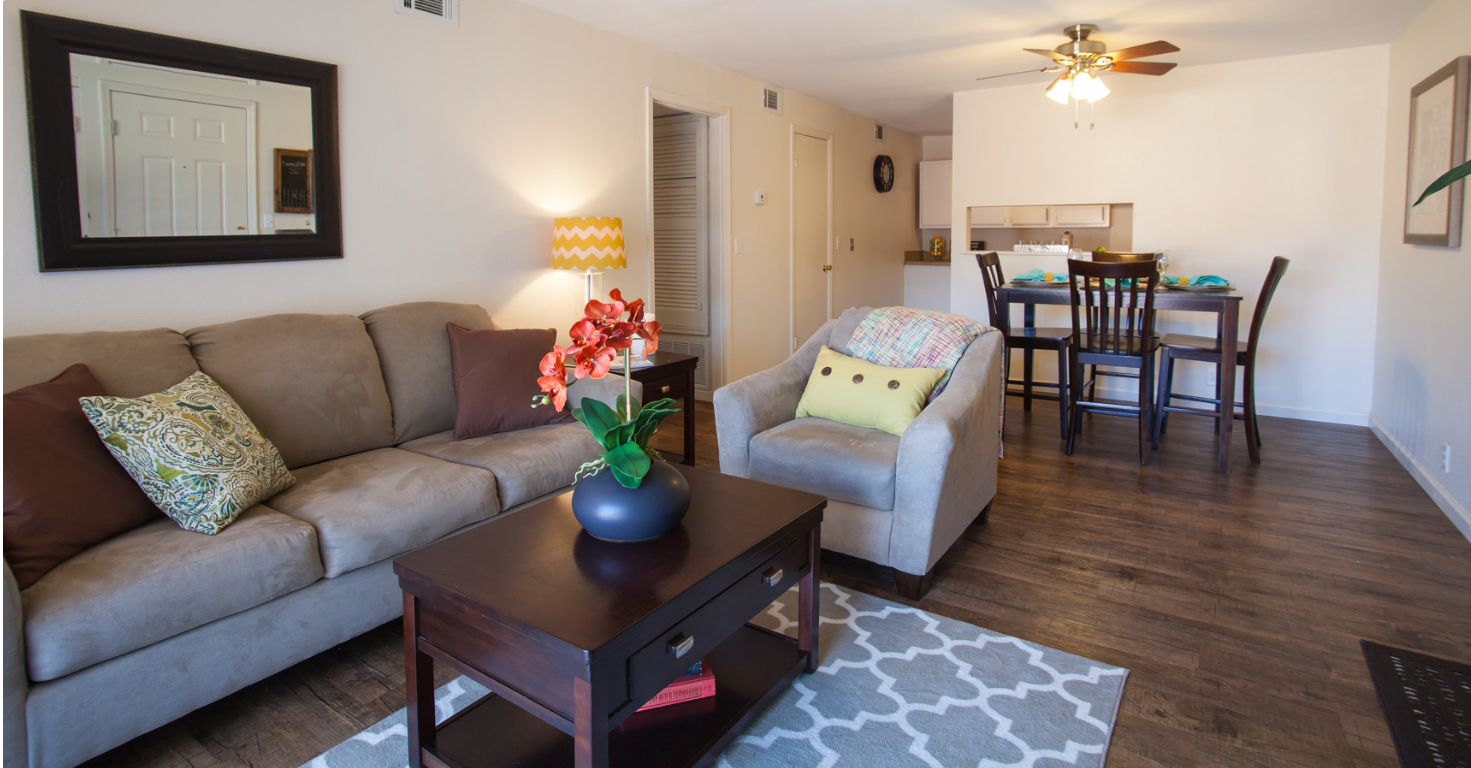 A living room with a couch , chair and coffee table