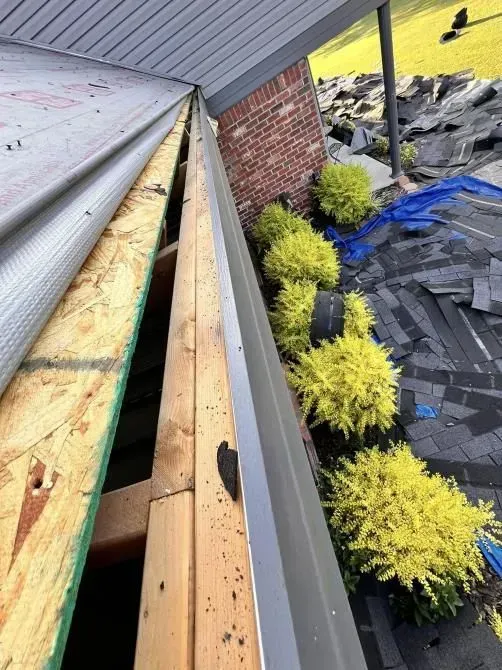 A gutter is being installed on the side of a house.