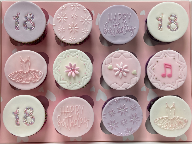 A box of cupcakes for a girl 's 18th birthday