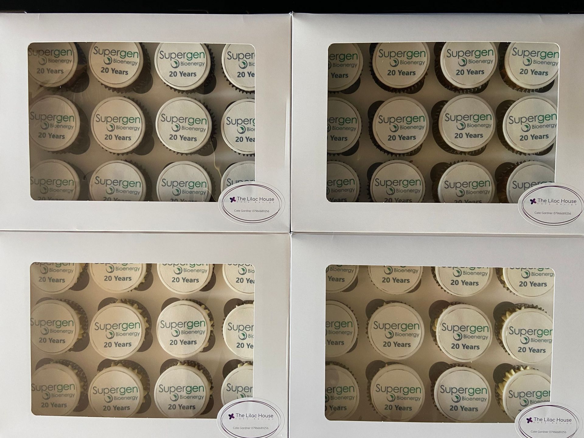 Four boxes of cupcakes with the word super on them