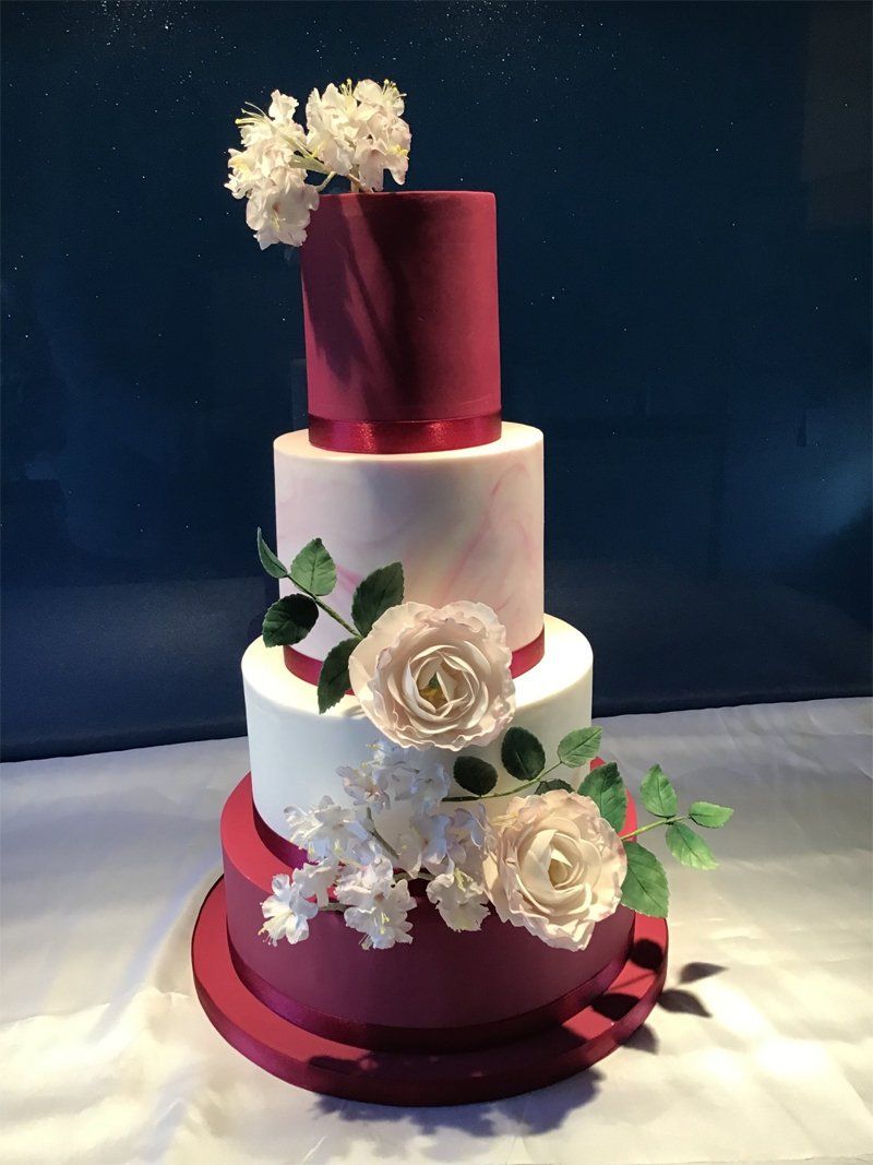 brown and gold wedding cake with edible flowers