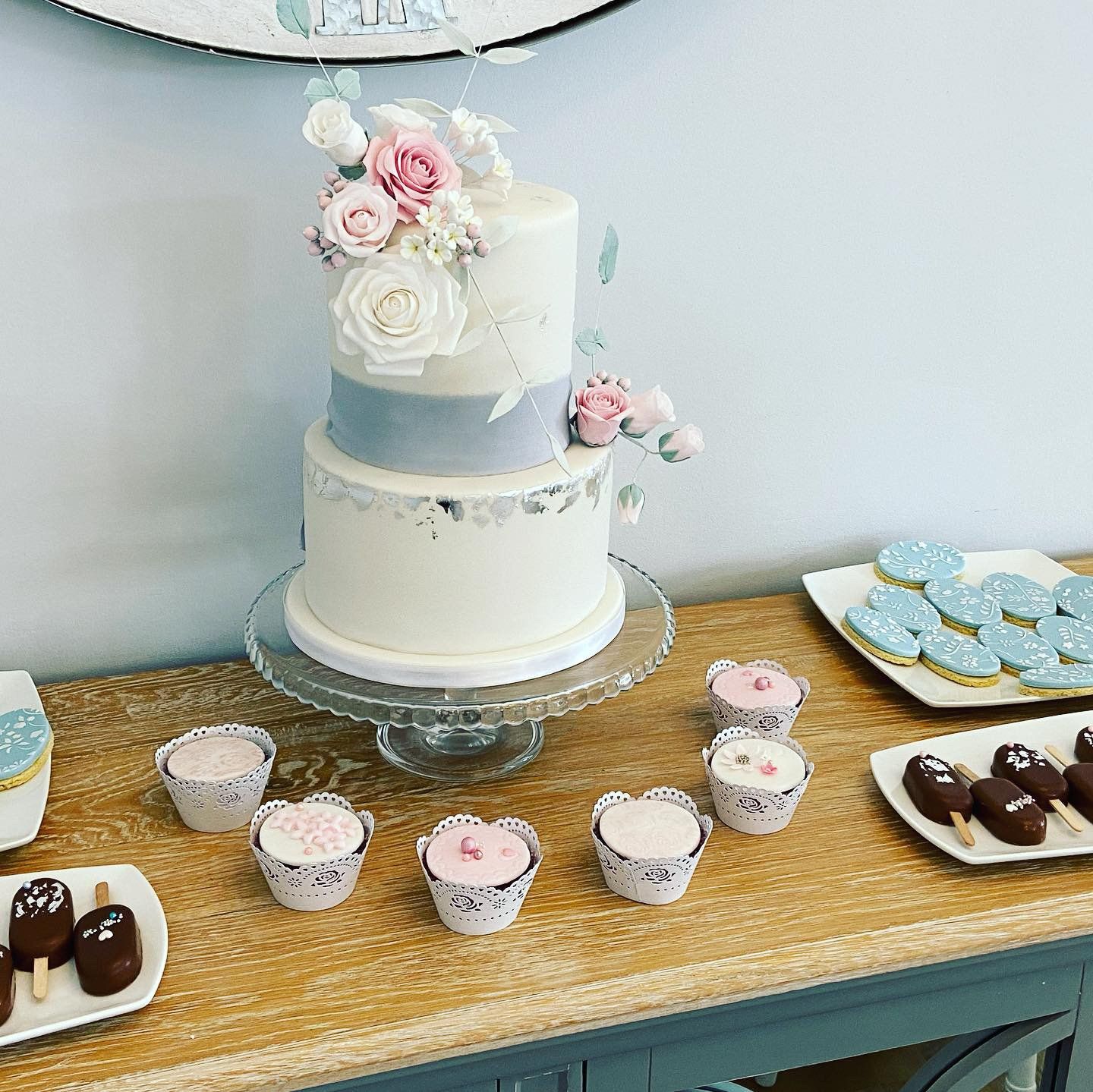 A table with a cake and cupcakes on it