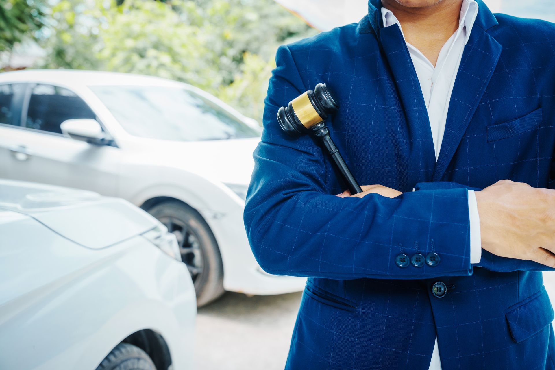 Lawyer in a Blue Suit and Holding a Gavel In Front Of cars | Salem, OR - Smith Morgan LLP