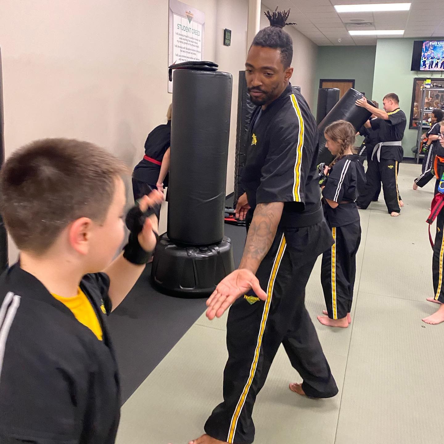 A group of people are practicing martial arts in a gym