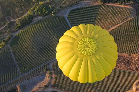A hot air ballon over vineyards in Napa, CA.