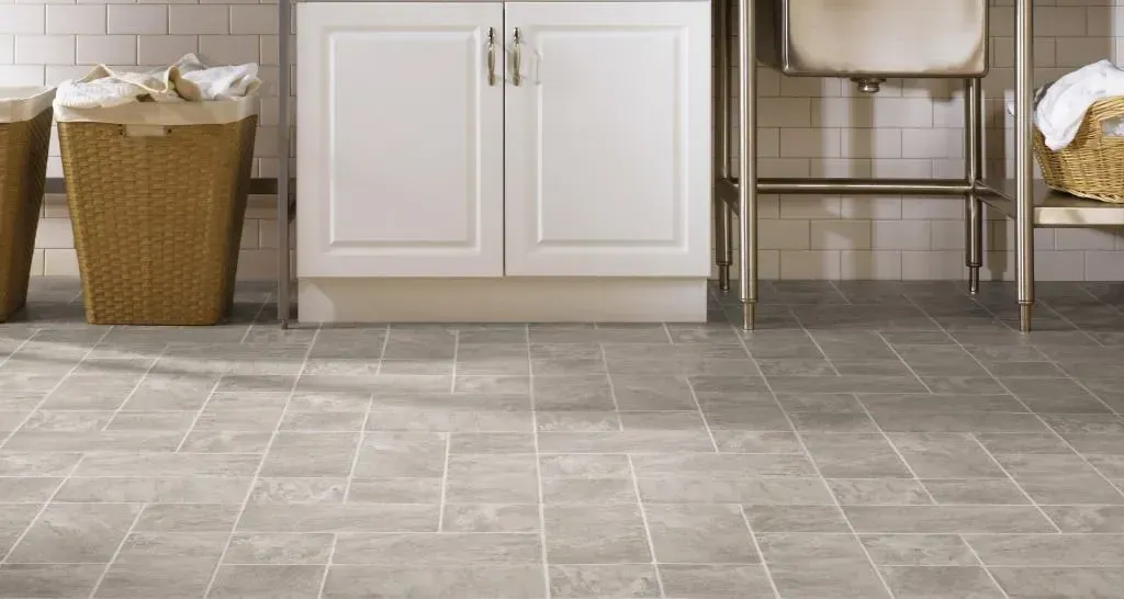 A laundry room with wicker baskets and a sink.
