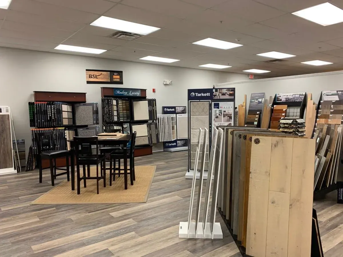 There is a table and chairs in the middle of the room.