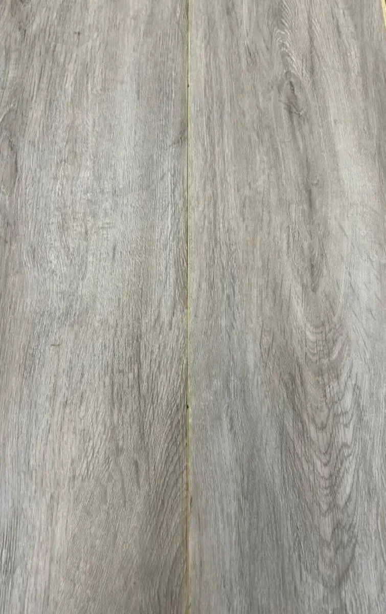 A close up of a gray tile that looks like wood.