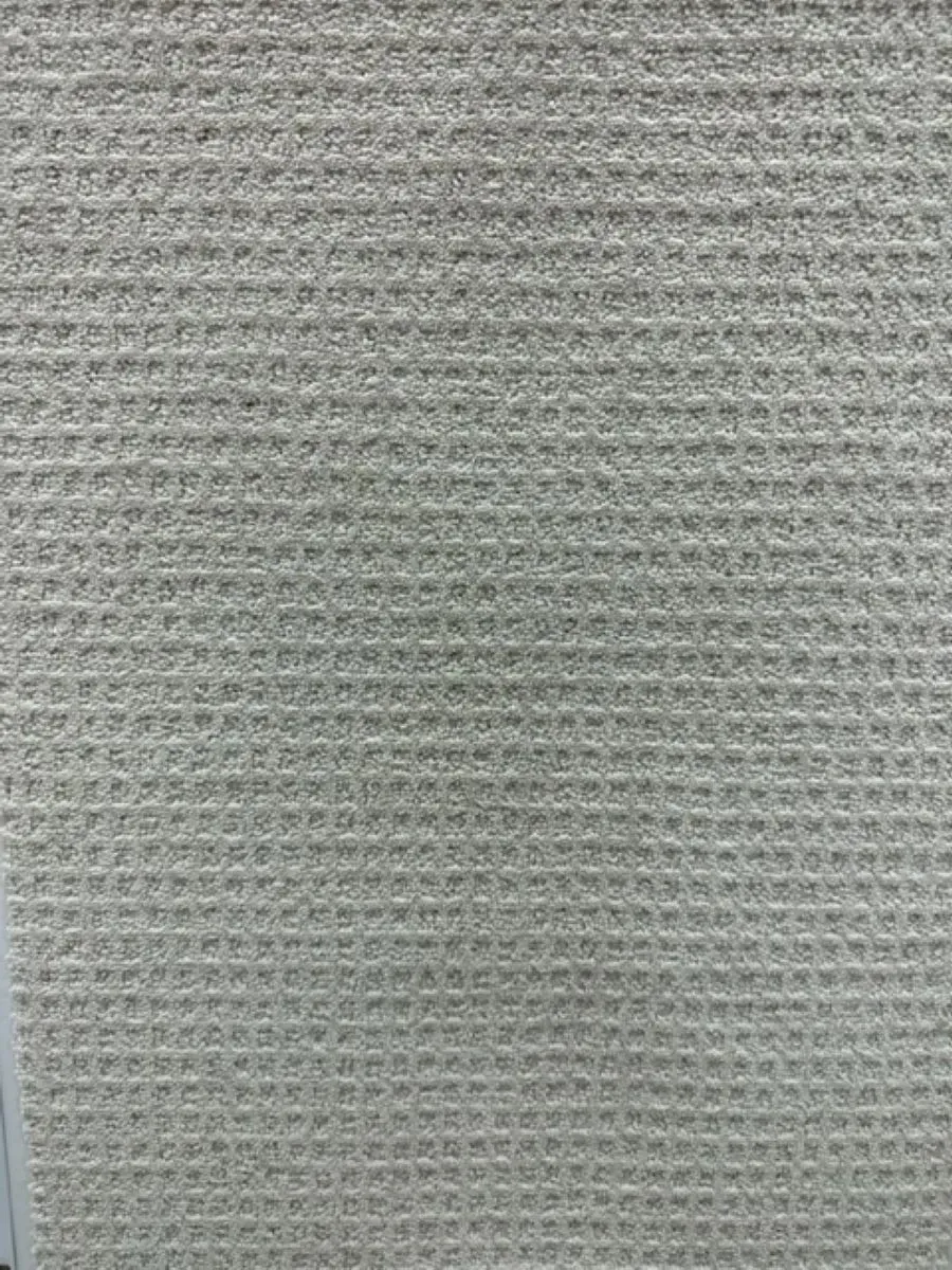 A close up of a piece of white fabric with a waffle pattern.