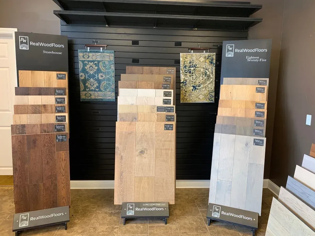 A display of different types of hardwood flooring in a store.