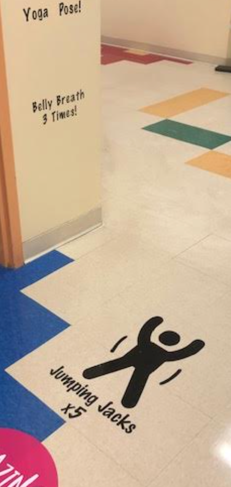 A sign on the floor says jumping jacks
