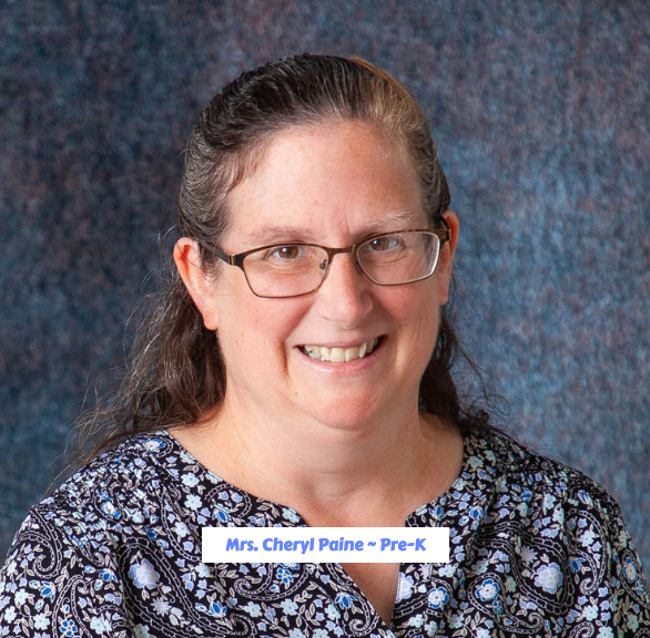 A woman wearing glasses and a purple sweater is smiling for the camera.