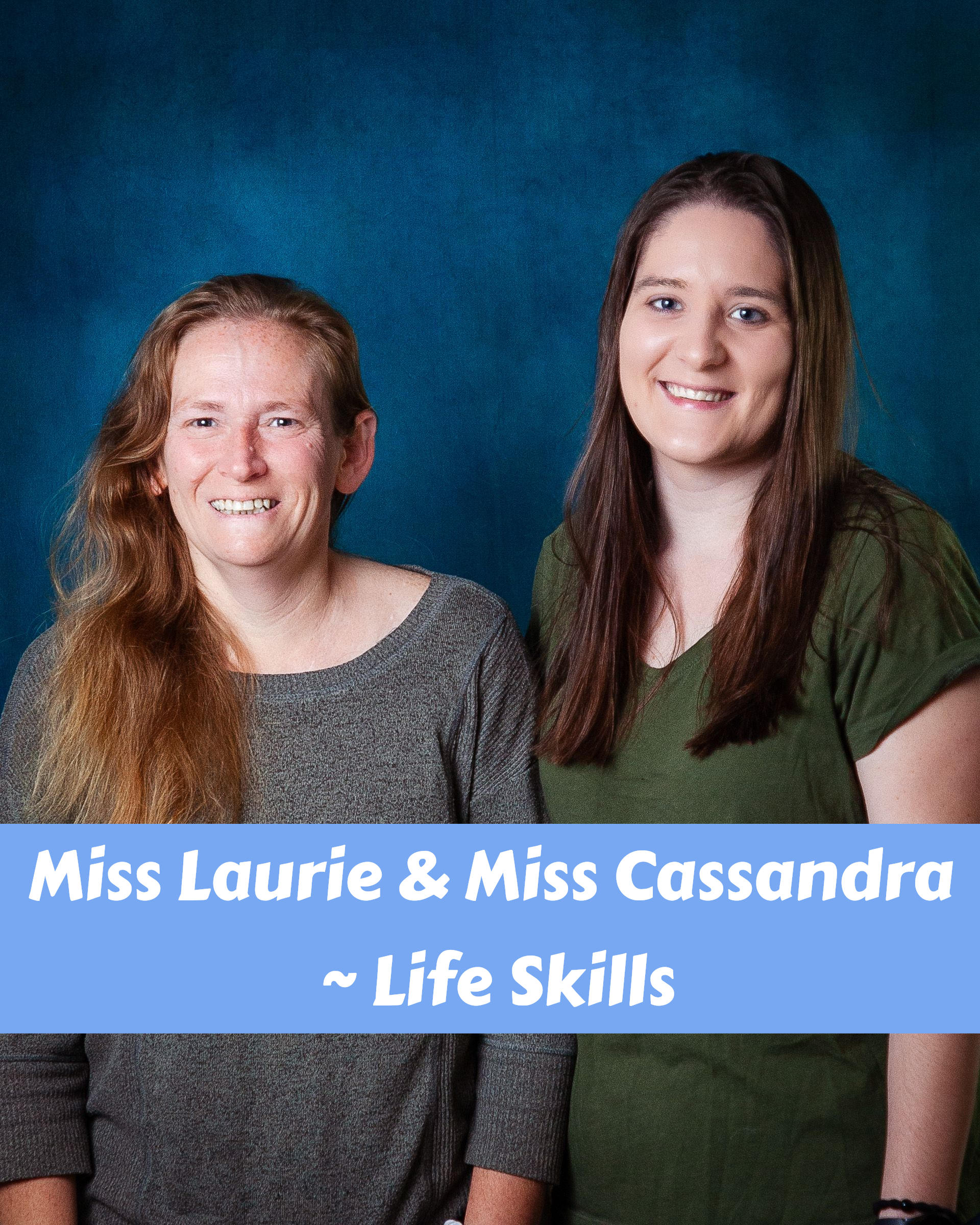 A woman with long red hair is smiling for the camera