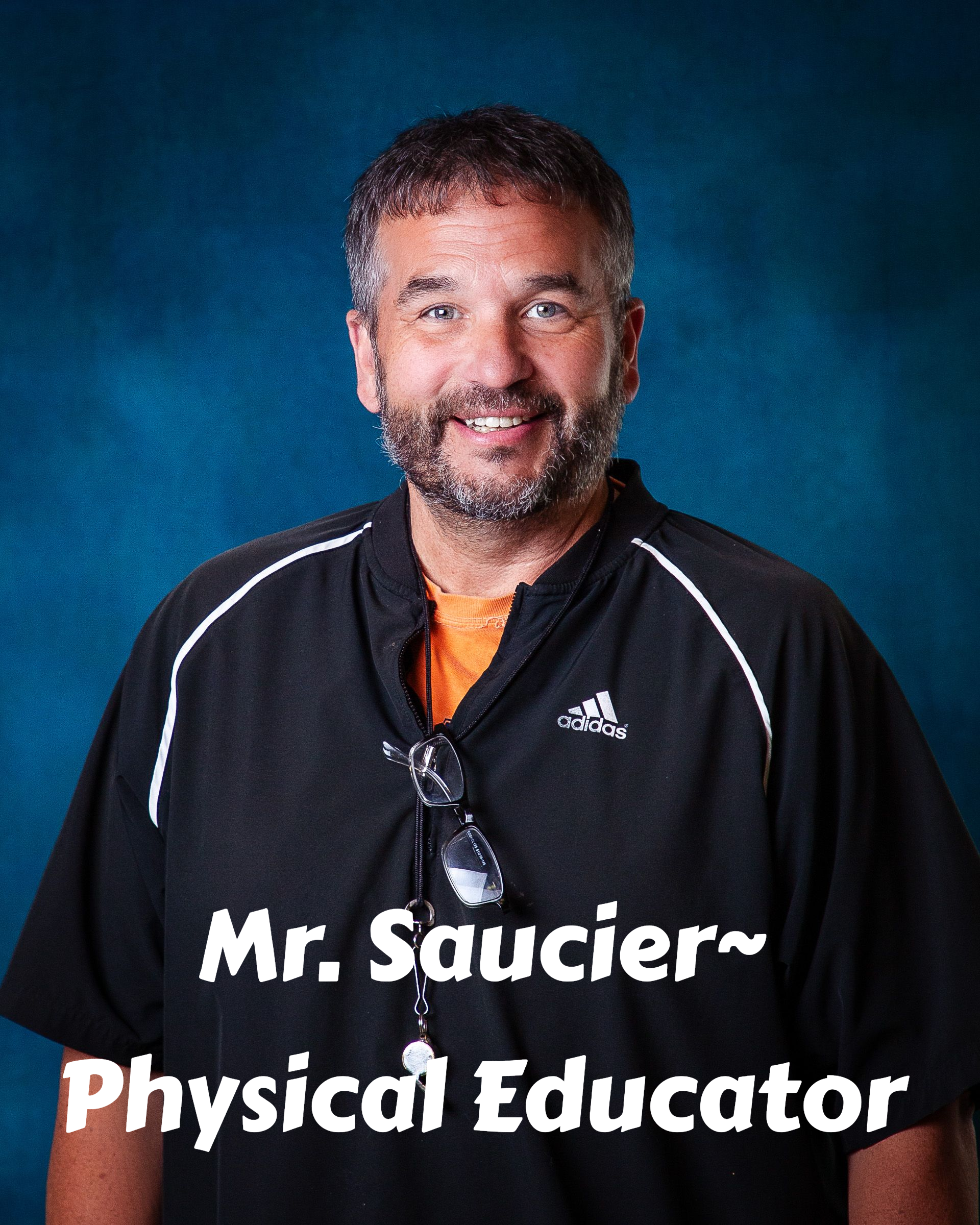 A man with a beard is wearing a grey hoodie