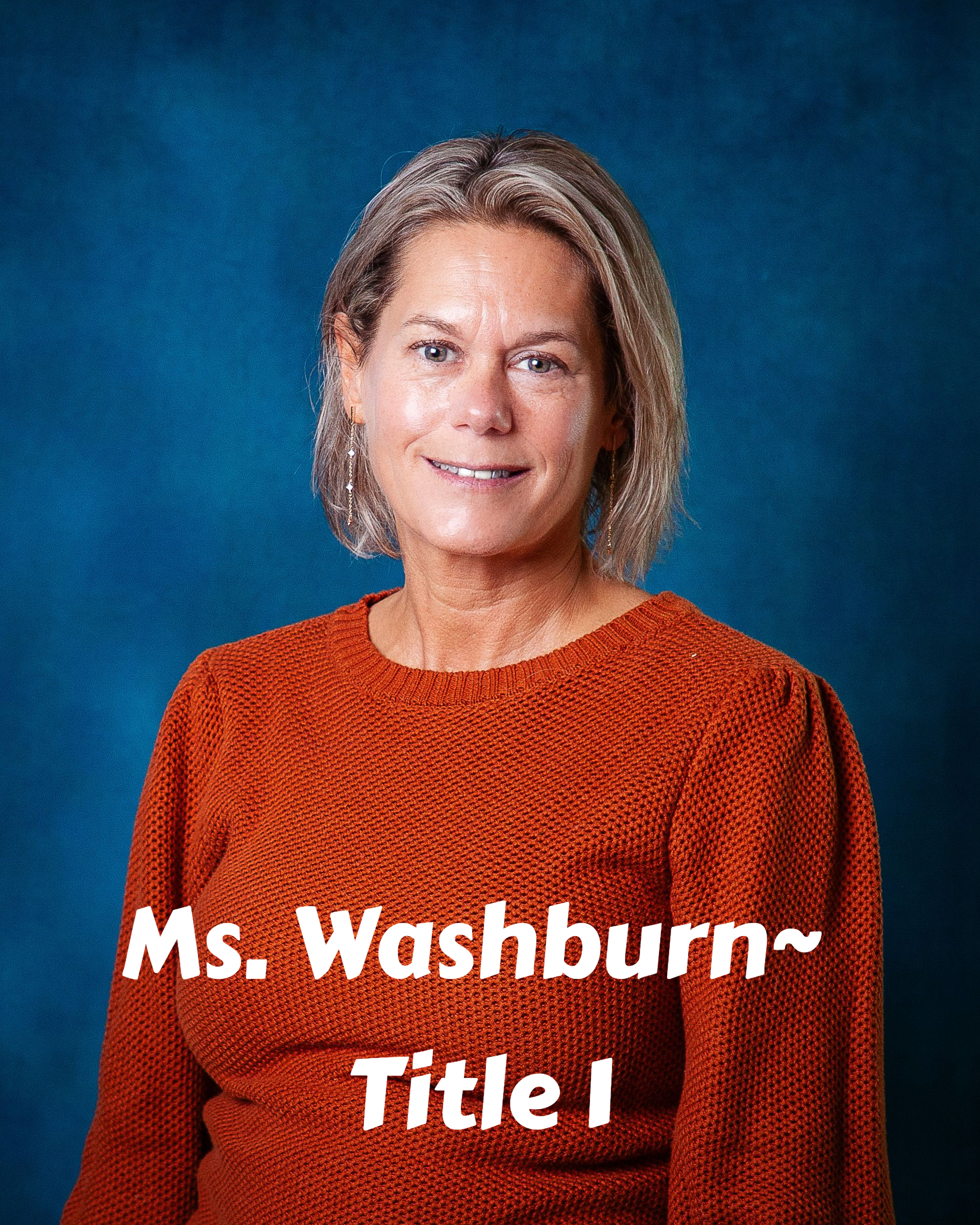 A woman in a green shirt is smiling for the camera.