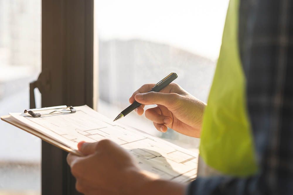 A man is writing on a clipboard with a pen.