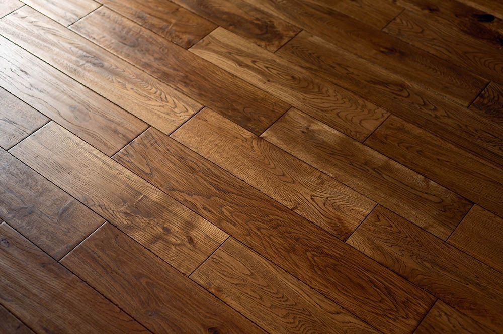 A close up of a wooden floor with a diagonal pattern