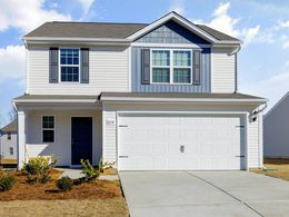 A white house with a blue door and shutters