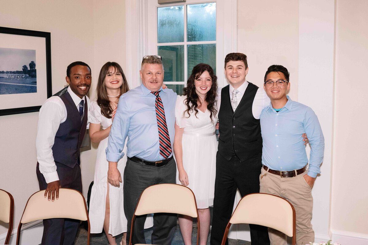 A group of people are posing for a picture in a room.