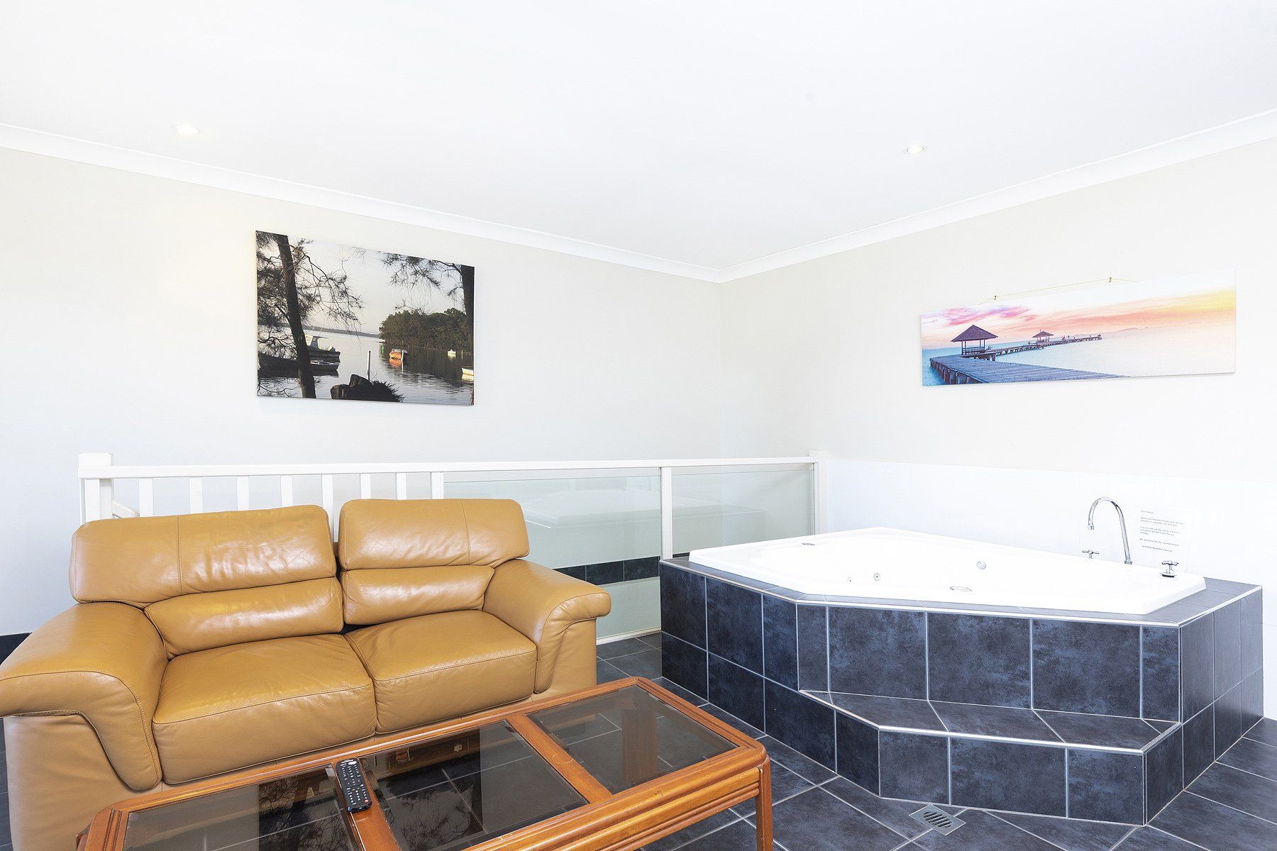 bathroom with hot tub and sofa