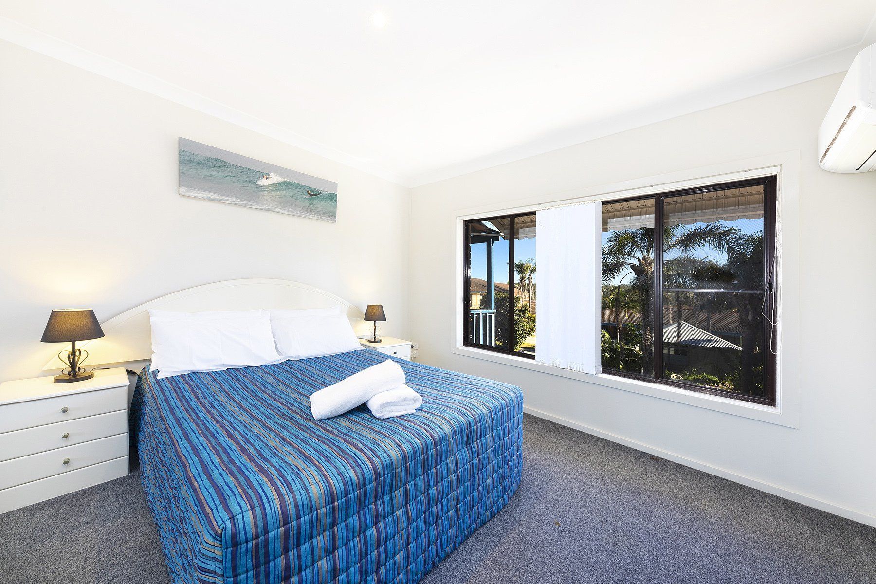 bed with blue mattress and window