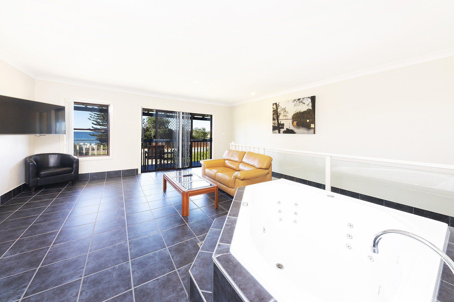 bathroom with hot tub and tile floor