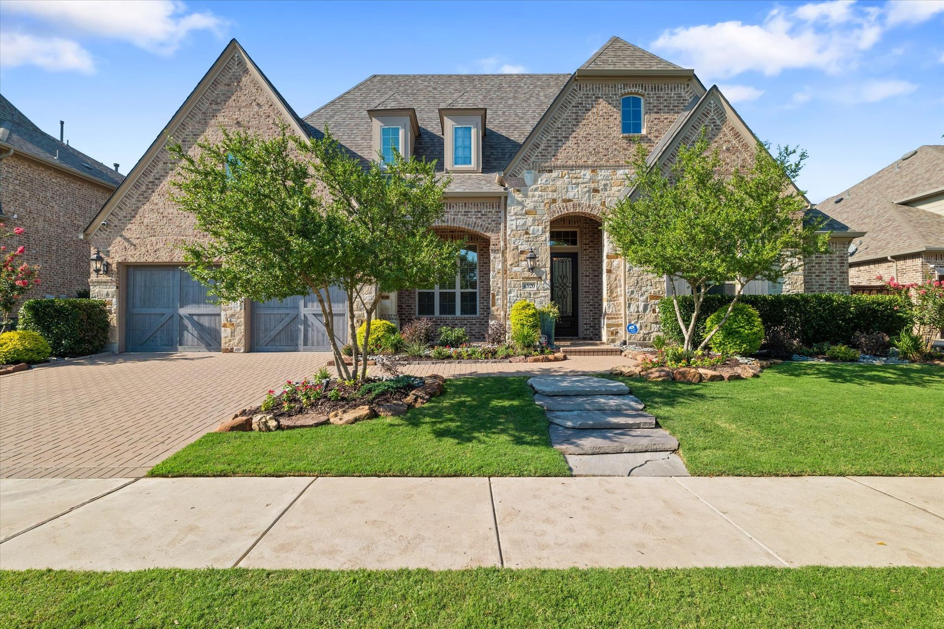 A large brick house with a lush green lawn in front of it for sale by Luke Wiler