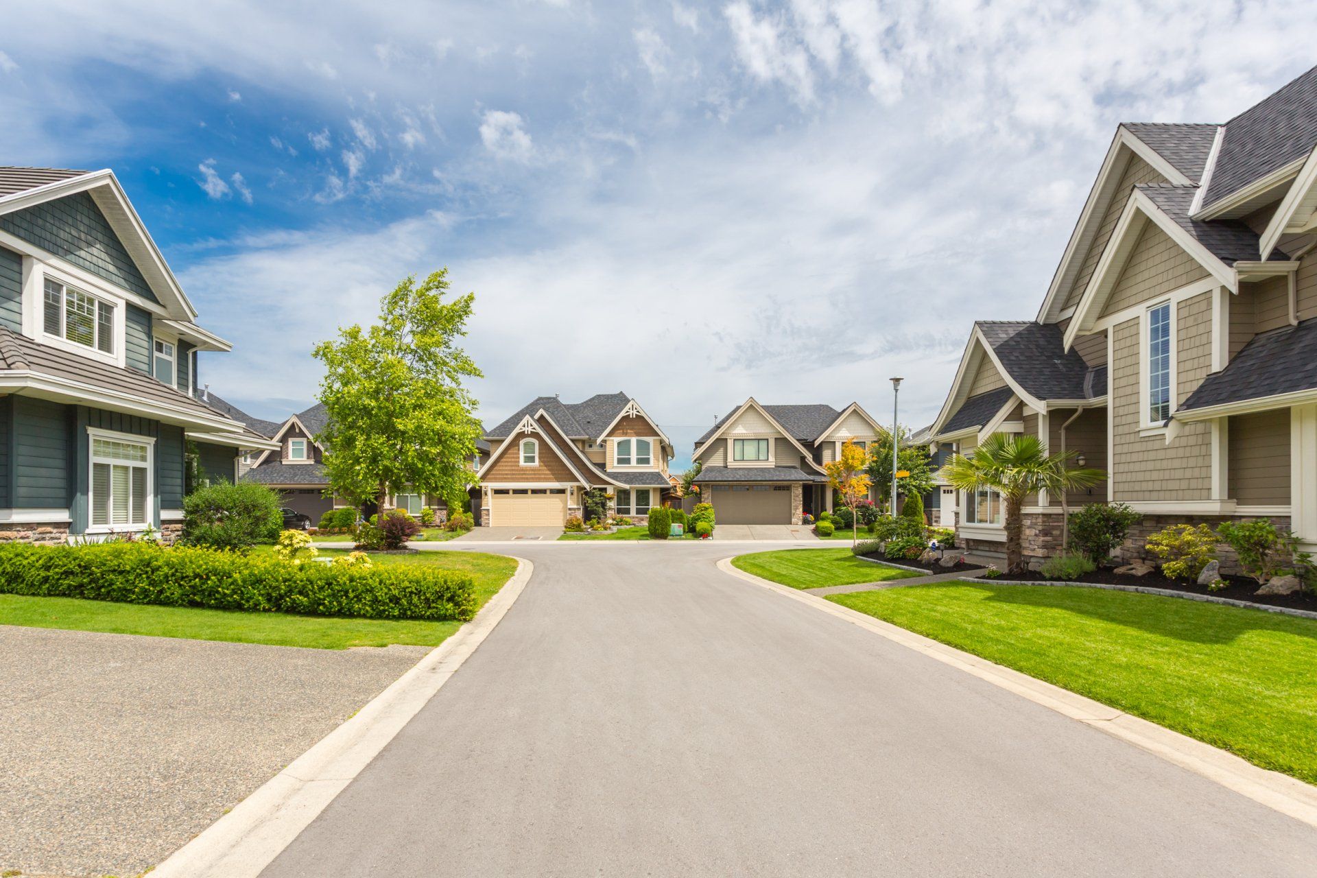 Nicely trimmed and manicured garden in front of a luxury house on a sunny summer day