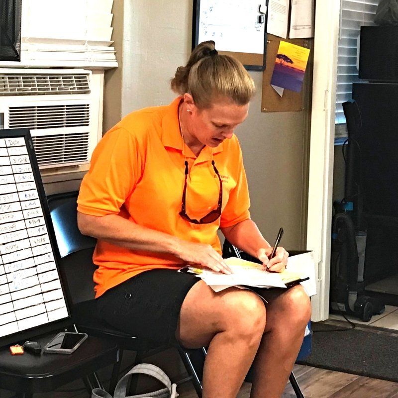 young woman in orange t-shirt filling the form