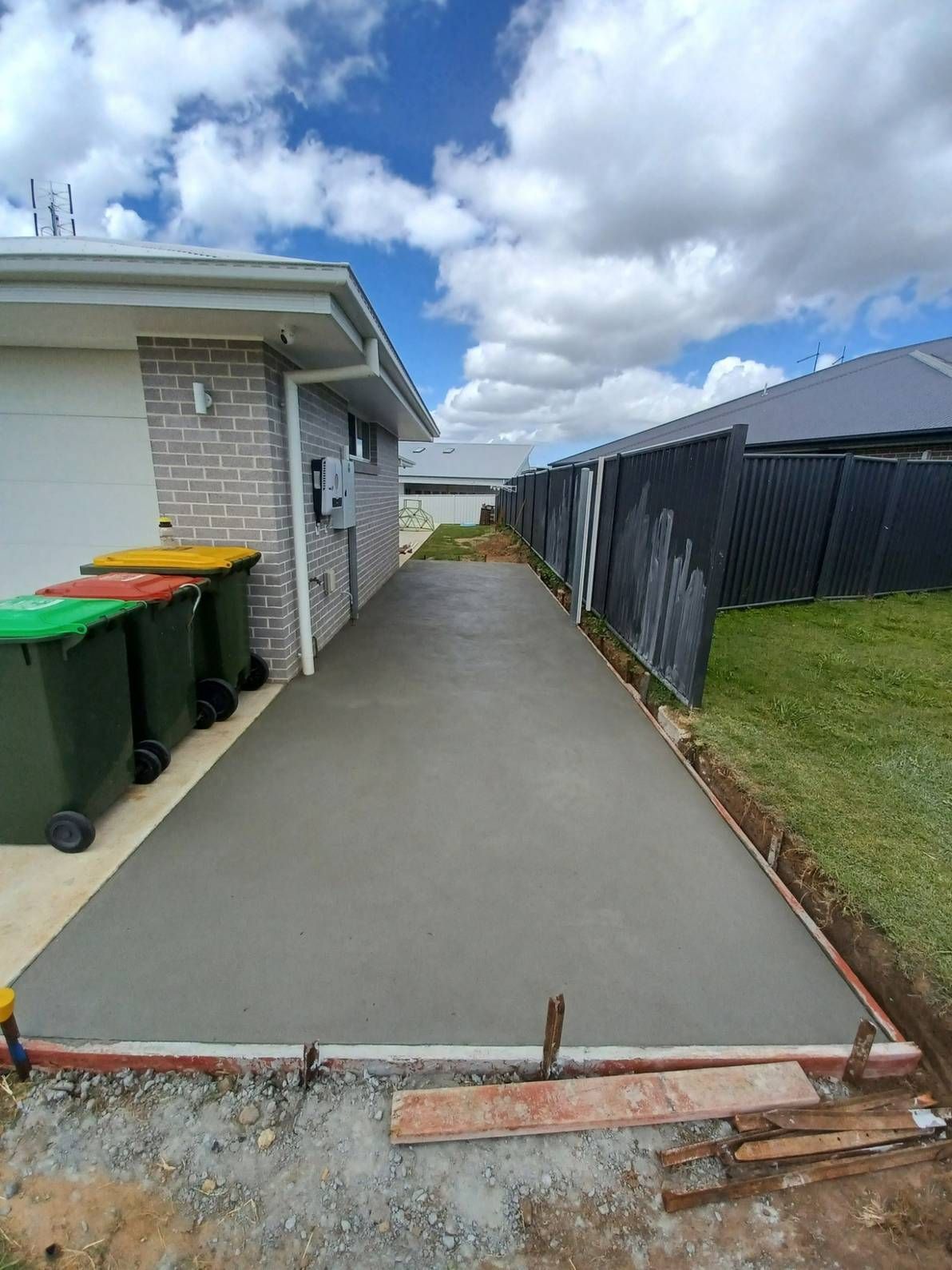 A Concrete Driveway is Being Built in Front of a House — Brocksolid Concrete in Pillar Valley, NSW