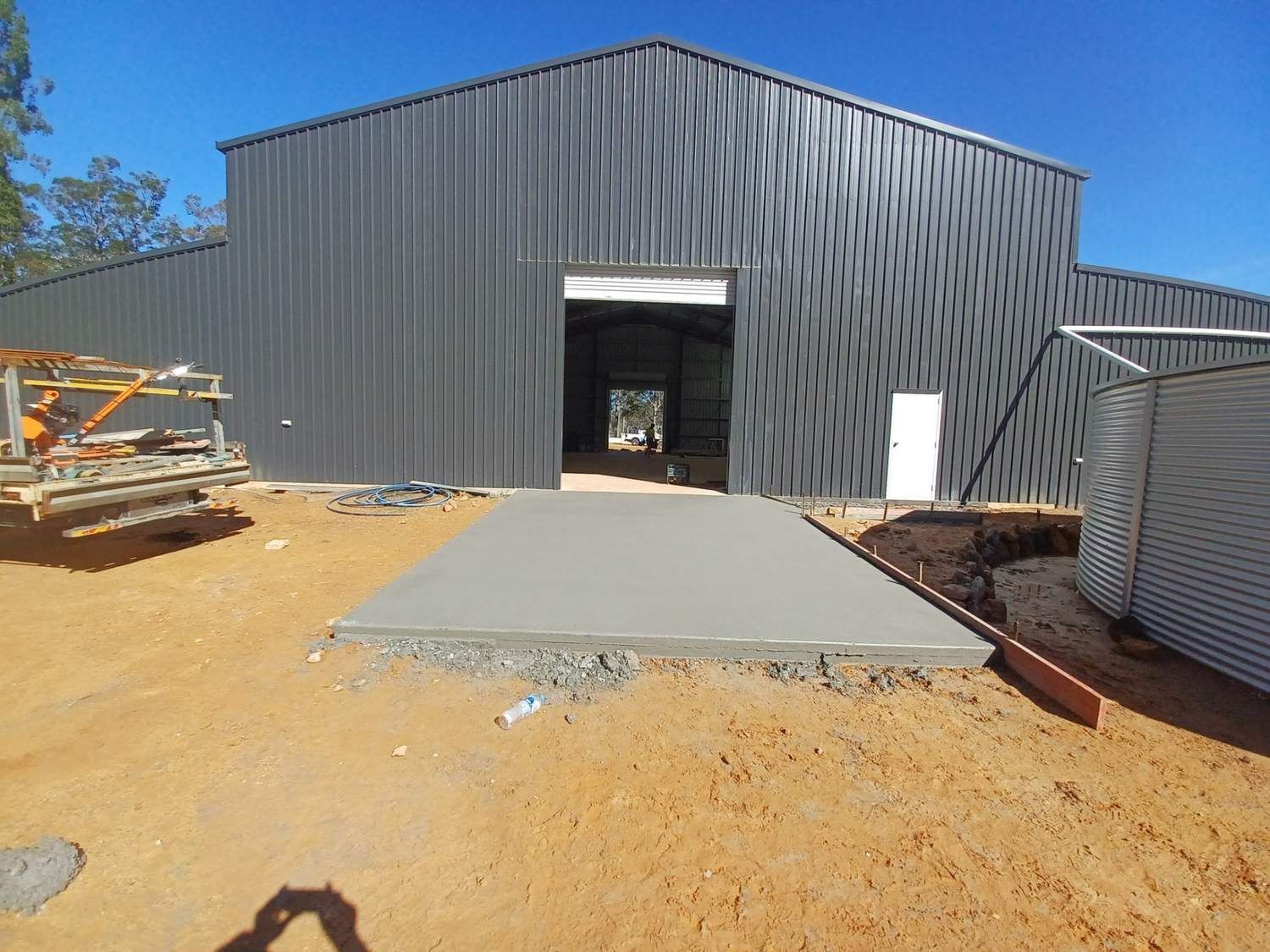 A Large Building With a Concrete Walkway in Front of It — Brocksolid Concrete in Pillar Valley, NSW