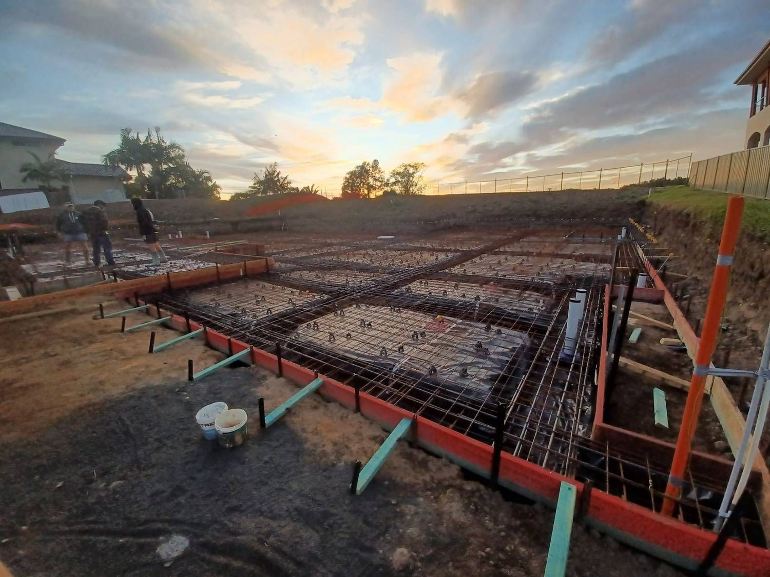 A Construction Site With a Sunset in the Background — Brocksolid Concrete in Pillar Valley, NSW
