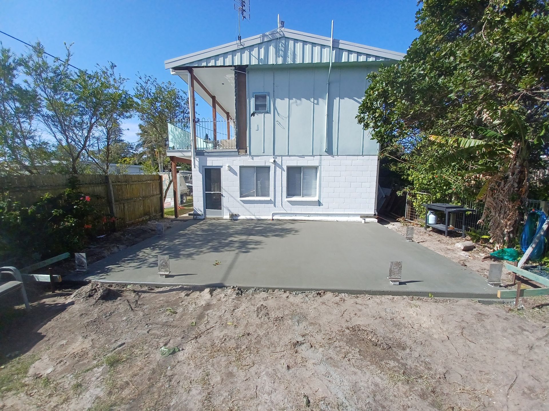 Freshly poured concrete slab in front of residential house.— Brocksolid Concrete in Pillar Valley, NSW