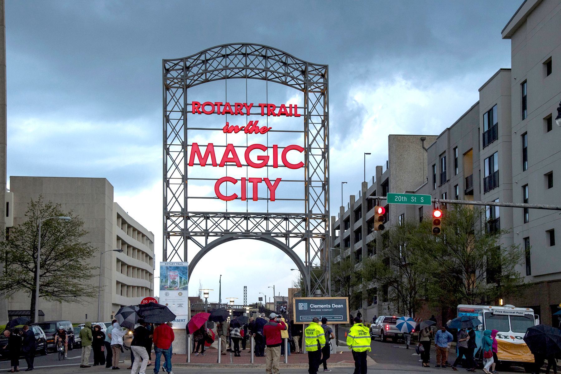 People are walking under a sign that says magic city
