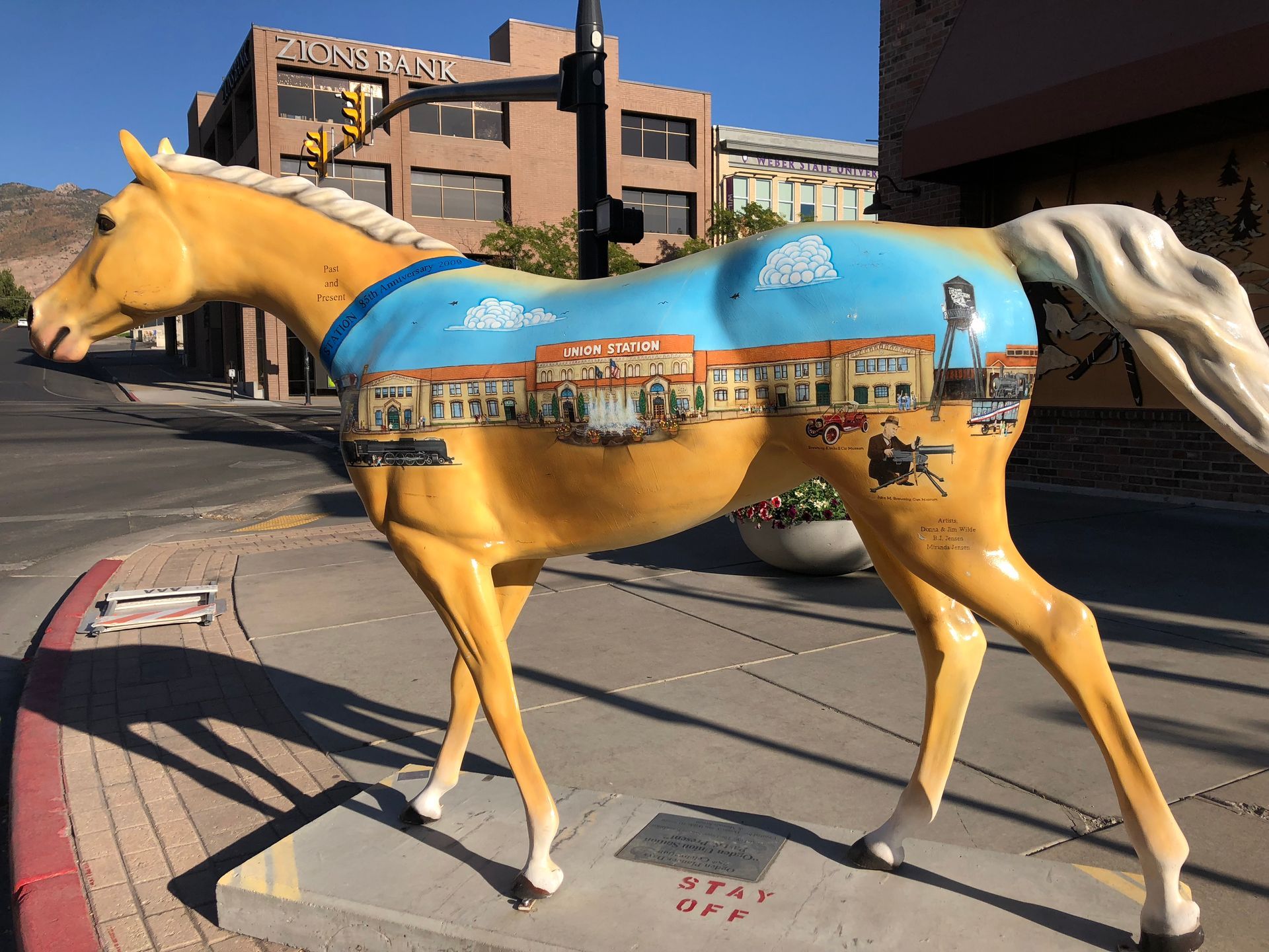 A statue of a horse with a painting on its back