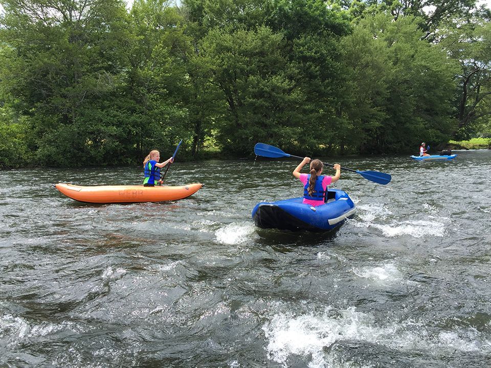 A group of people are kayaking down a river.