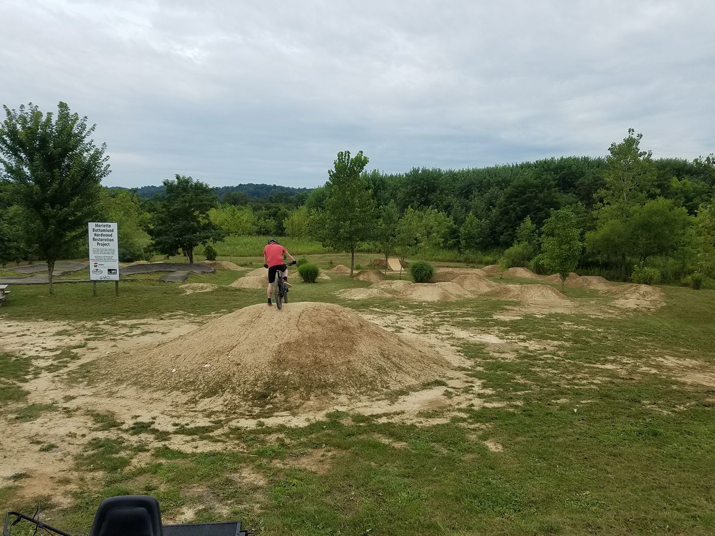 A person is riding a bike on a dirt road.
