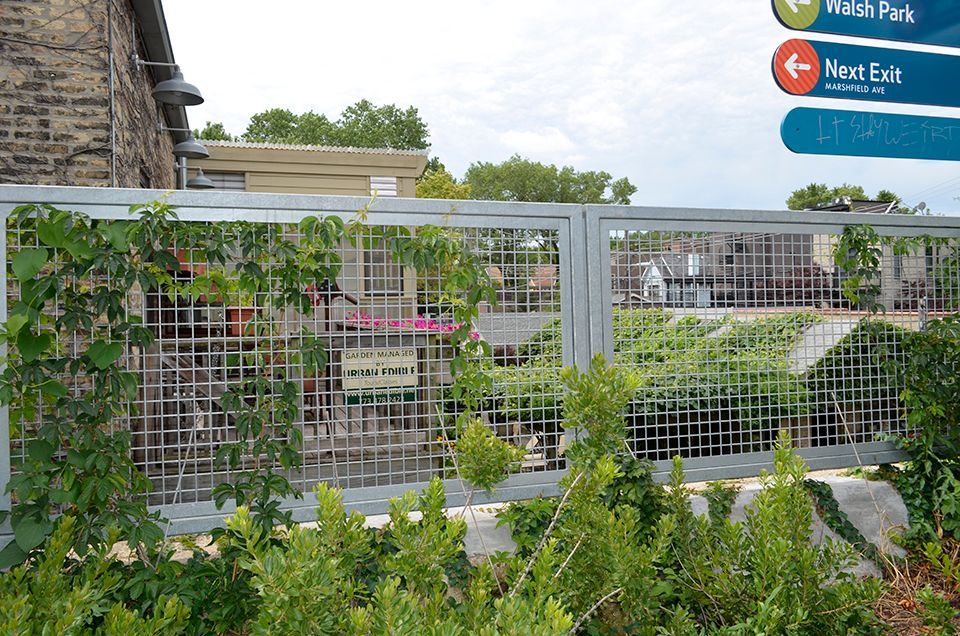 A fence with a sign in the background that says not fair