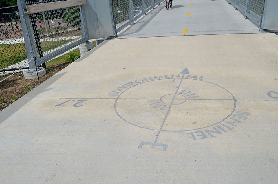 A bridge with a compass on the side of it
