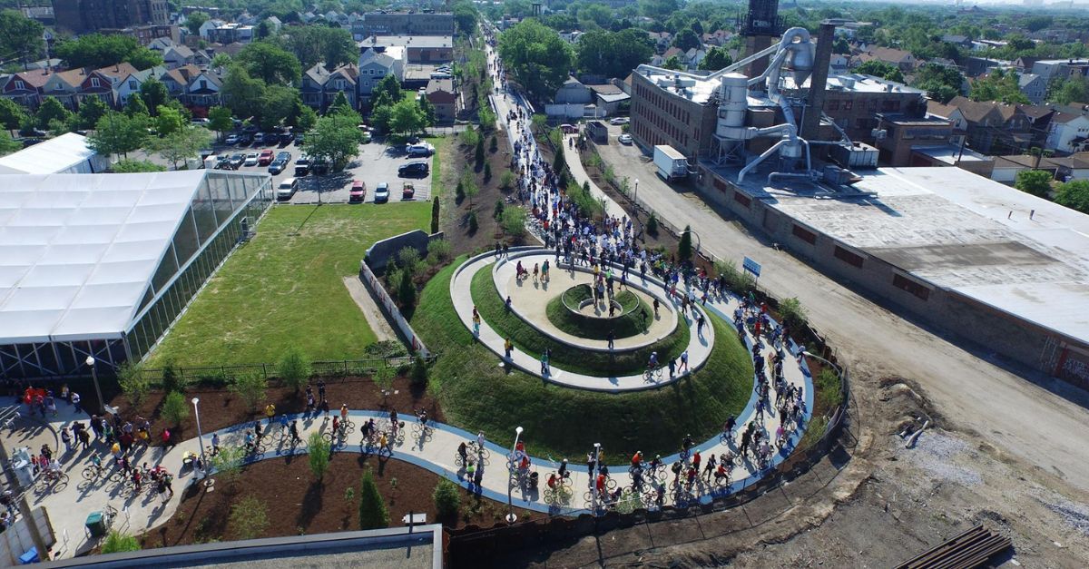 An aerial view of a large group of people standing on top of a hill.