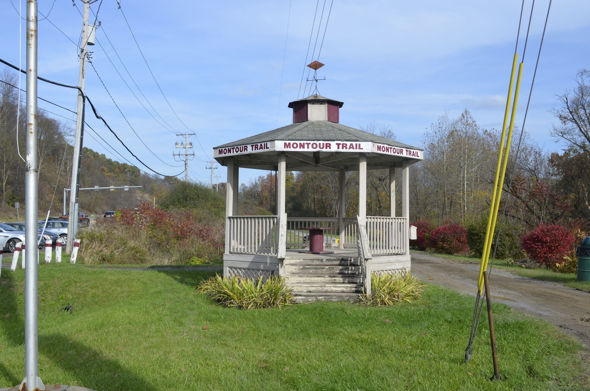 A gazebo in the middle of a grassy field that says ' music trail ' on it