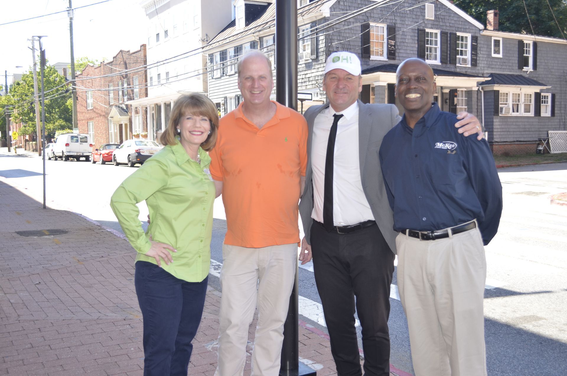 A group of people posing for a picture in front of a building